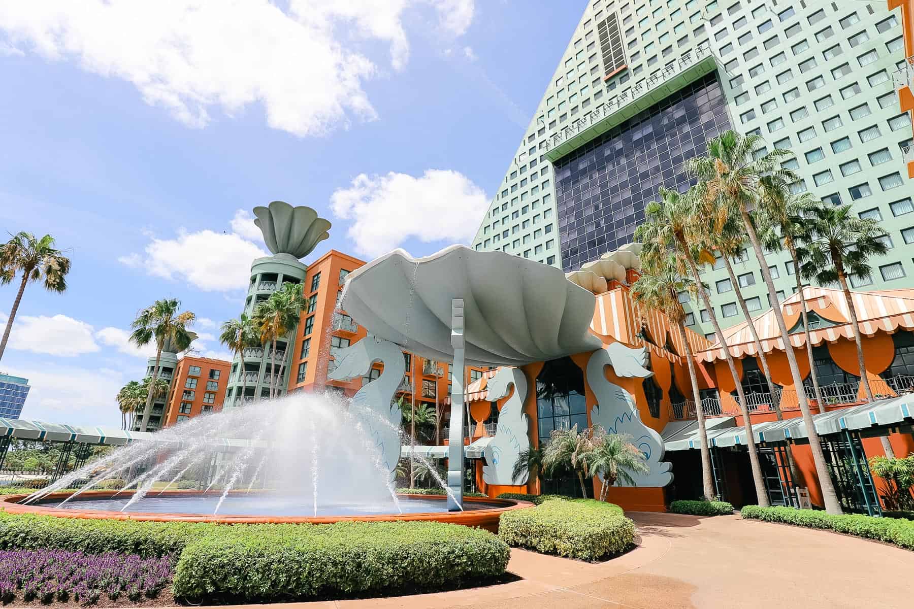 A fountain pouring from a clamshell in front of the Dolphin Hotel at Walt Disney World.