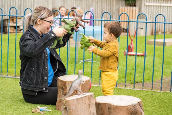 Throwing plush dinosaurs fun outdoor play area at Thrive Childcare, promoting early childhood development and active learning in a safe, colourful setting.