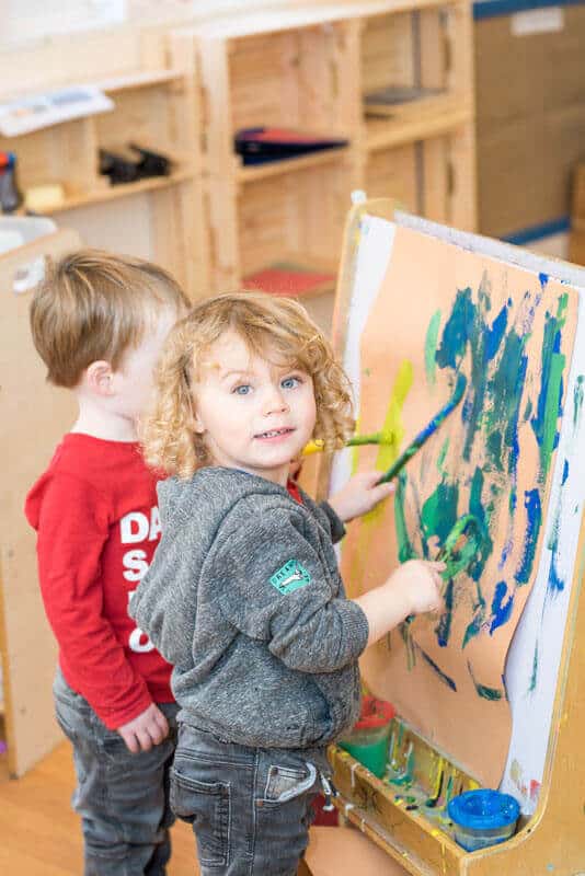 Children engaging in creative painting activities at Thrive Childcare, fostering early development and artistic skills. Safe, nurturing environment for preschool children to learn and play.