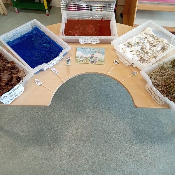 Colourful sensory play bins with natural and textured materials for early childhood development, learning, and exploration at Thrive Childcare.