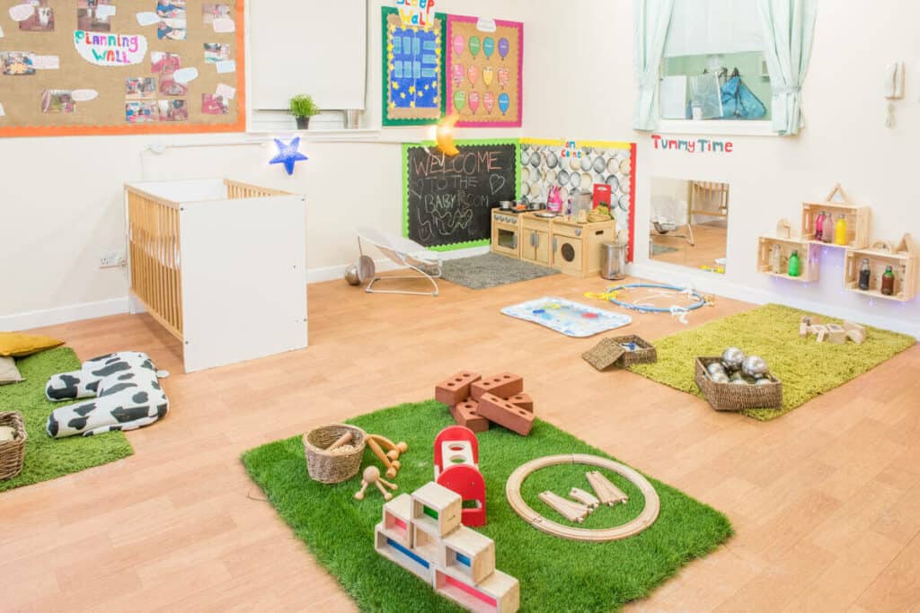 Bright, welcoming indoor nursery playroom at Thrive Childcare featuring soft mats, educational toys, and colourful decorations designed for early childhood development and childcare.