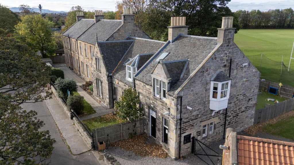 Bright, welcoming childcare centre housed in historic stone building with safe outdoor play area, located in a family-friendly community for early childhood education and care.