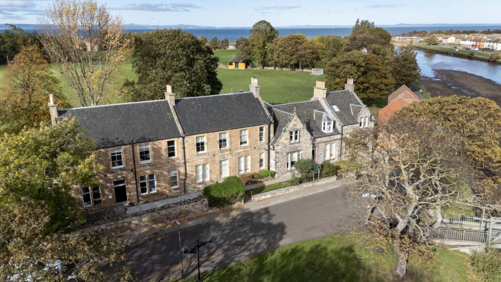 1. Aerial view of Thrive Childcare centre nestled among trees and greenery near a river, showcasing a welcoming environment for early childhood education and care.