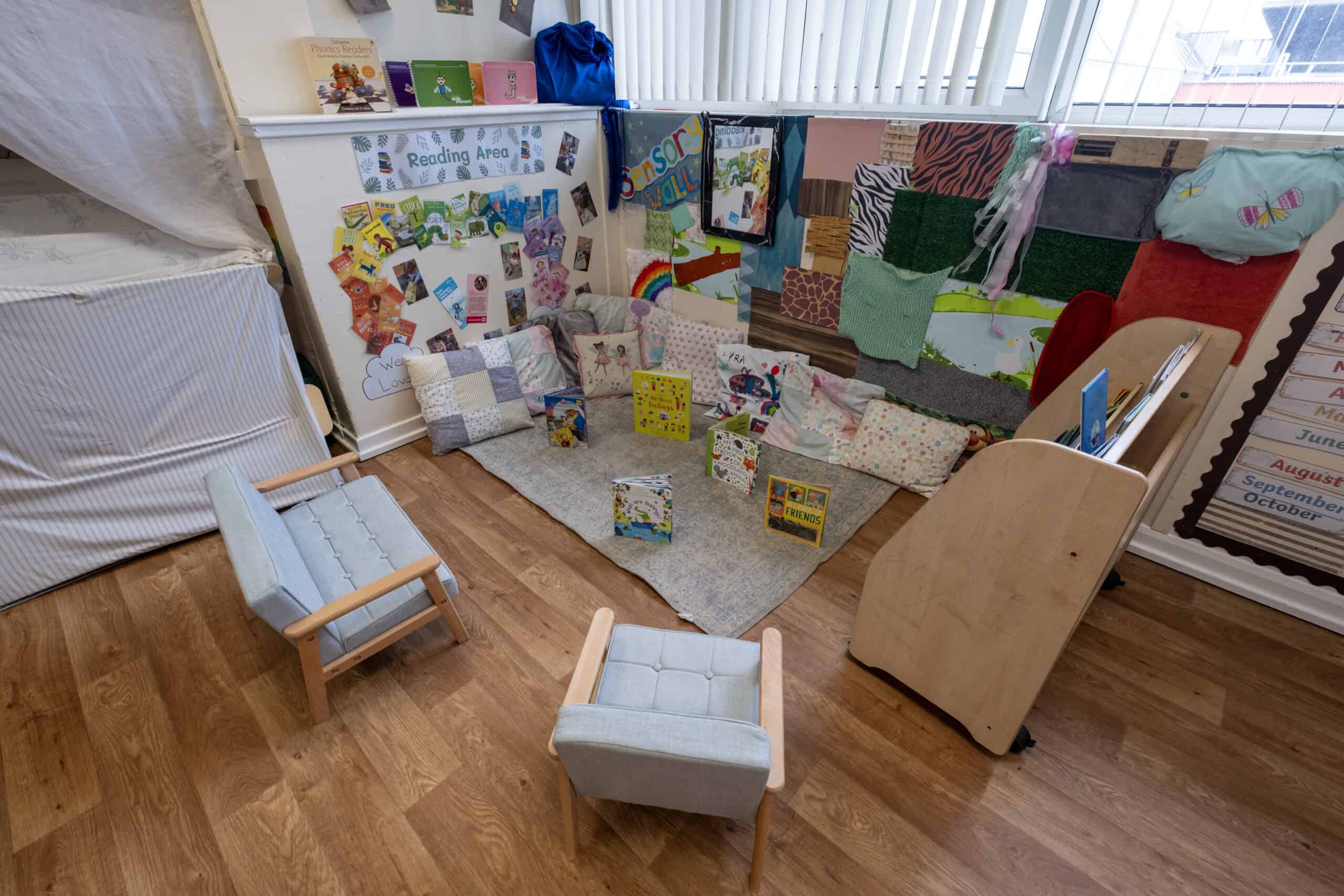 A colourful reading corner in a childcare setting, featuring books, cushions, and reading displays to foster literacy skills in young children. Perfect for early childhood education environments.