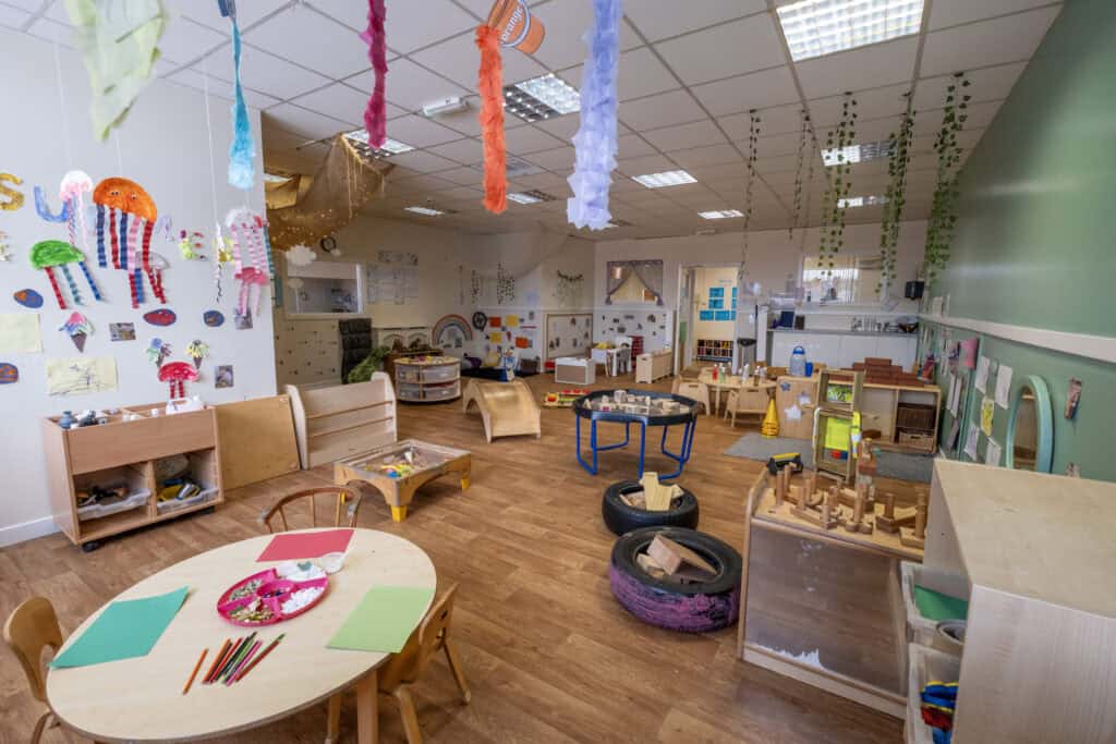 Bright indoor play area at Thrive Childcare with educational toys, colourful decorations, and safe space for early childhood development and learning.