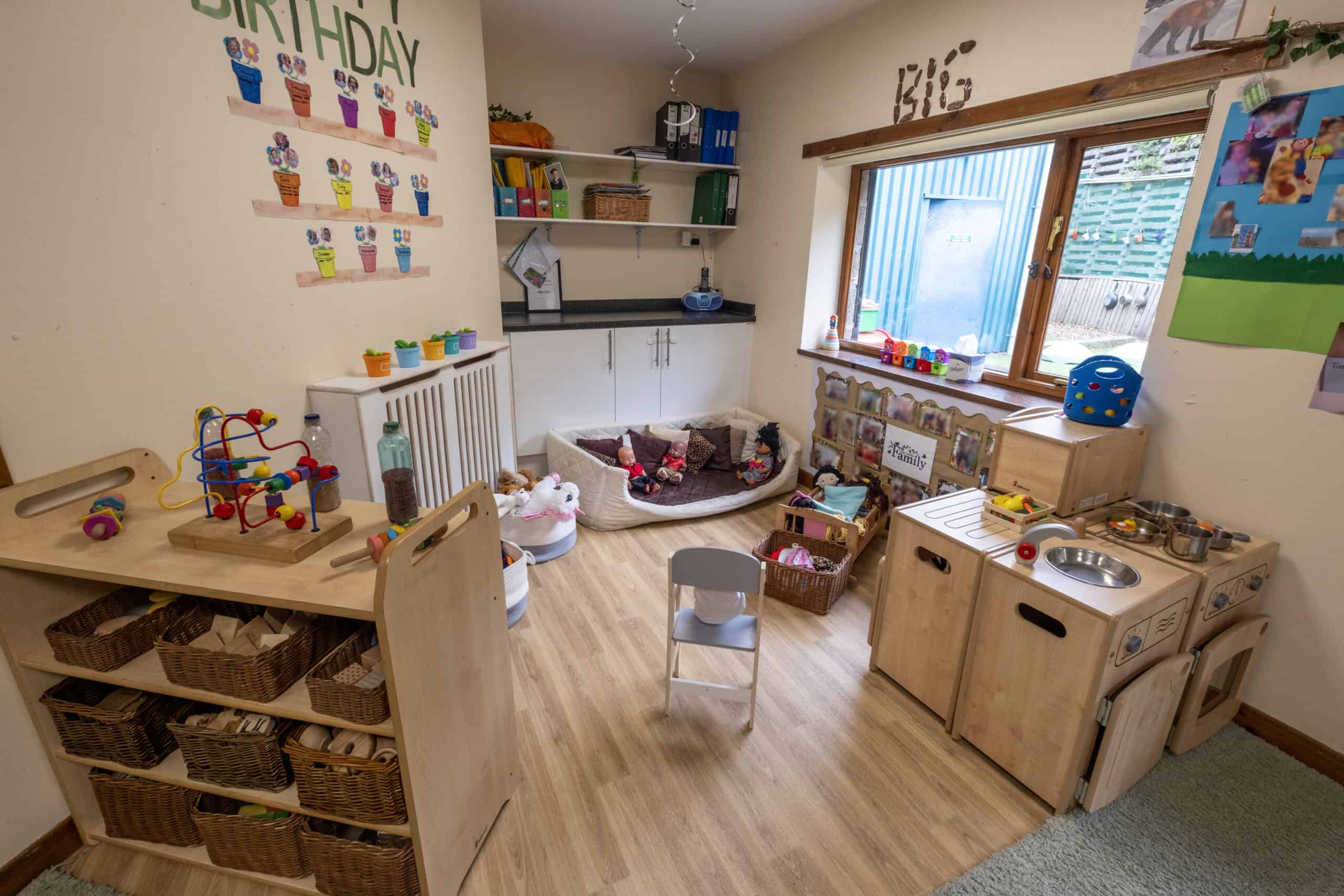Bright and inviting childcare playroom with toys, craft areas, and a cosy nook, offering a safe, engaging environment for young children at Thrive Childcare.