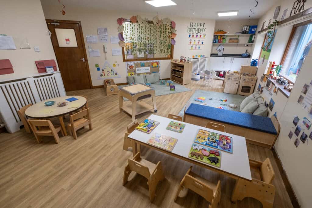 Bright, welcoming childcare classroom with age-appropriate toys, learning stations, and comfortable seating, designed by Thrive Childcare to nurture early childhood development and learning in a safe environment.