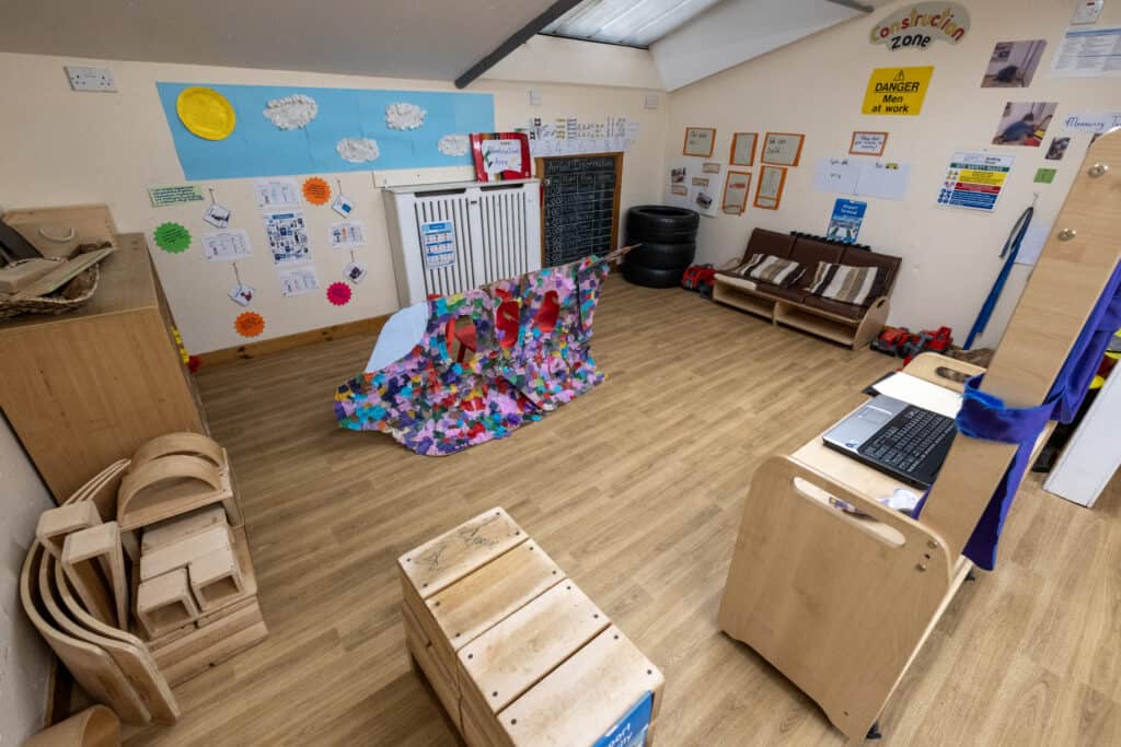 Colourful construction-themed play area in a Thrive Childcare classroom, with imaginative props, educational displays, and child-friendly furniture to encourage learning and creativity.