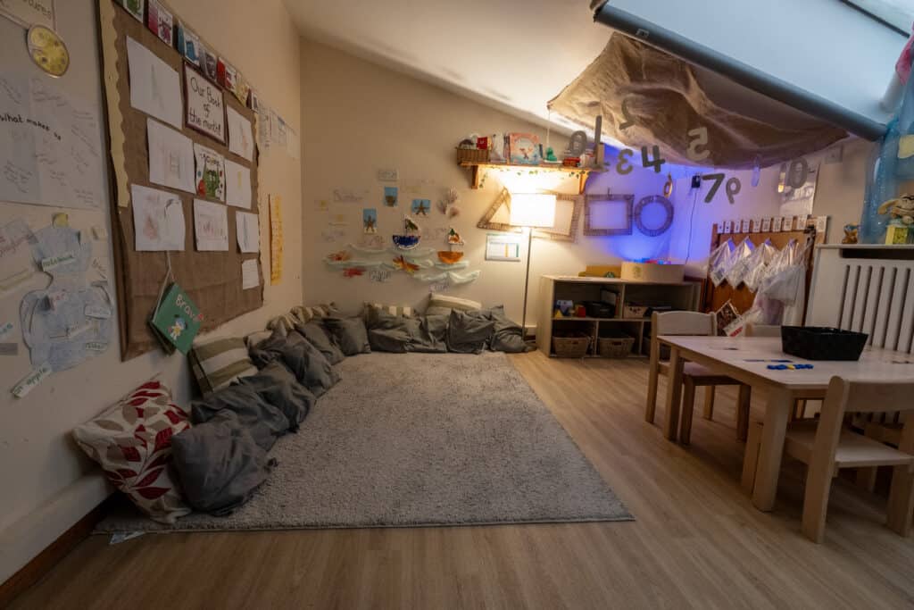 Bright, welcoming early childhood education classroom at Thrive Childcare with cosy reading and play areas, educational decorations, and child-friendly furniture supporting preschool learning and development.