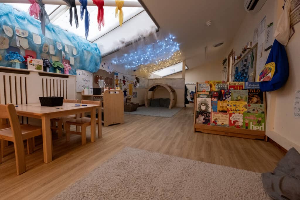Bright indoor playroom at Thrive Childcare with cosy reading nook, sensory area, and colourful educational displays, creating a nurturing environment for early childhood development.