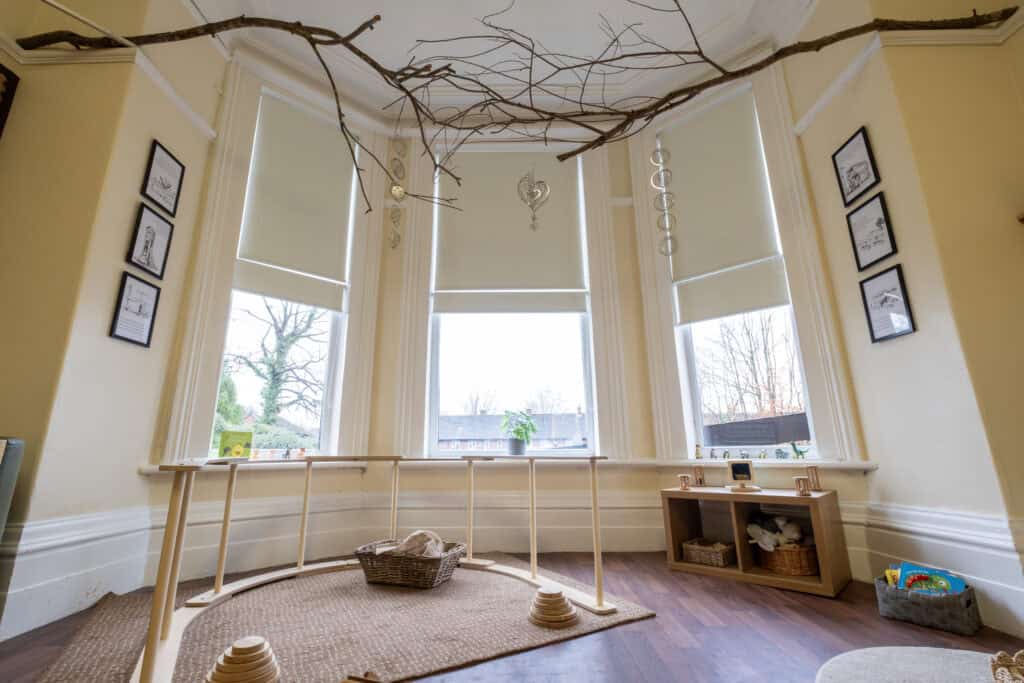 Bright and spacious children’s playroom at Thrive Childcare, featuring large windows, natural light, and child-friendly décor, creating a warm environment for early childhood development and learning.