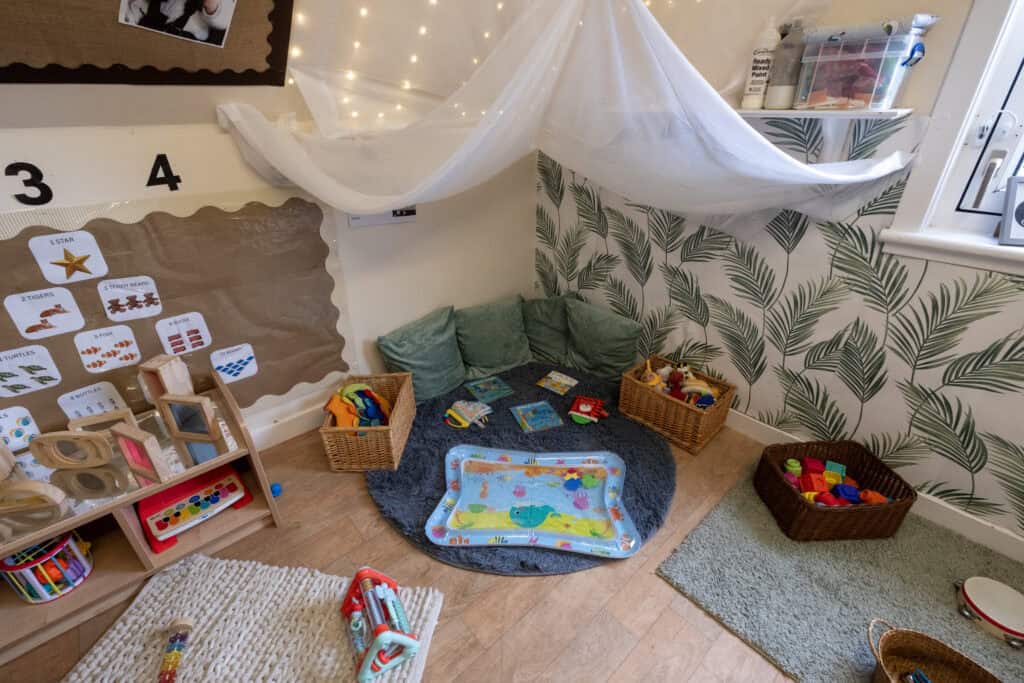 Bright nursery corner with soft cushions, colourful toys, and sensory play area at Thrive Childcare, creating a safe and engaging environment for children's development and early learning.