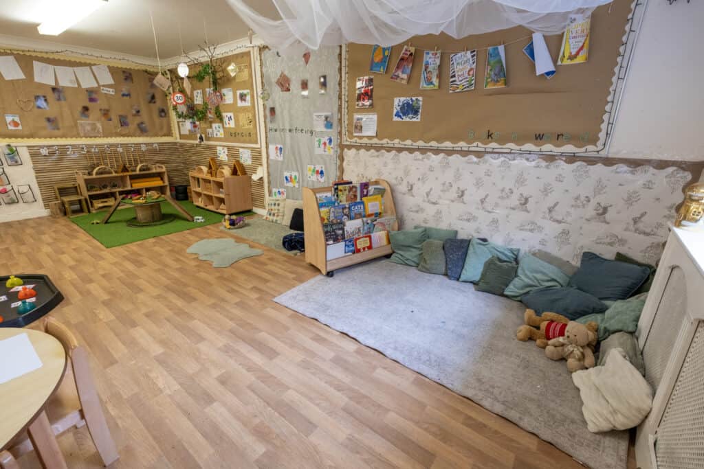 A welcoming preschool classroom at Thrive Childcare featuring reading nooks, soft seating, educational displays, and play areas designed for early childhood development and learning in a nurturing environment.