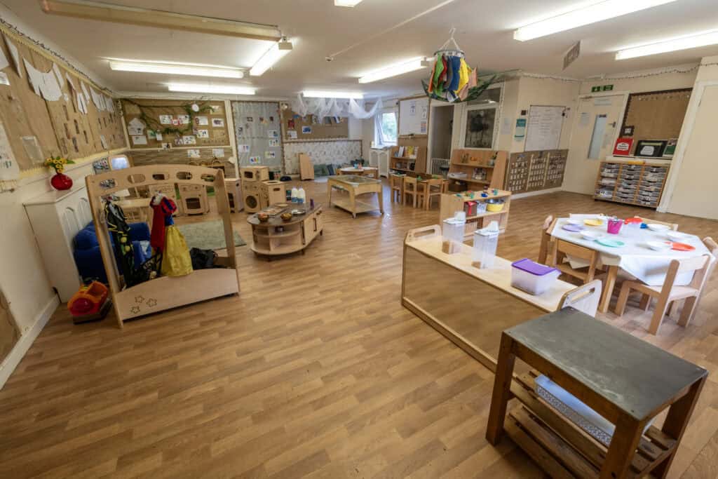 1. Bright and welcoming childcare classroom with play areas, educational displays, and child-friendly furniture at Thrive Childcare.