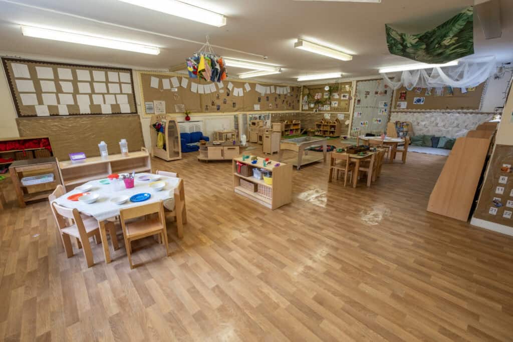 Bright and welcoming indoor childcare centre with play areas, learning stations, and child-friendly furniture, designed for early childhood development and parent peace of mind.