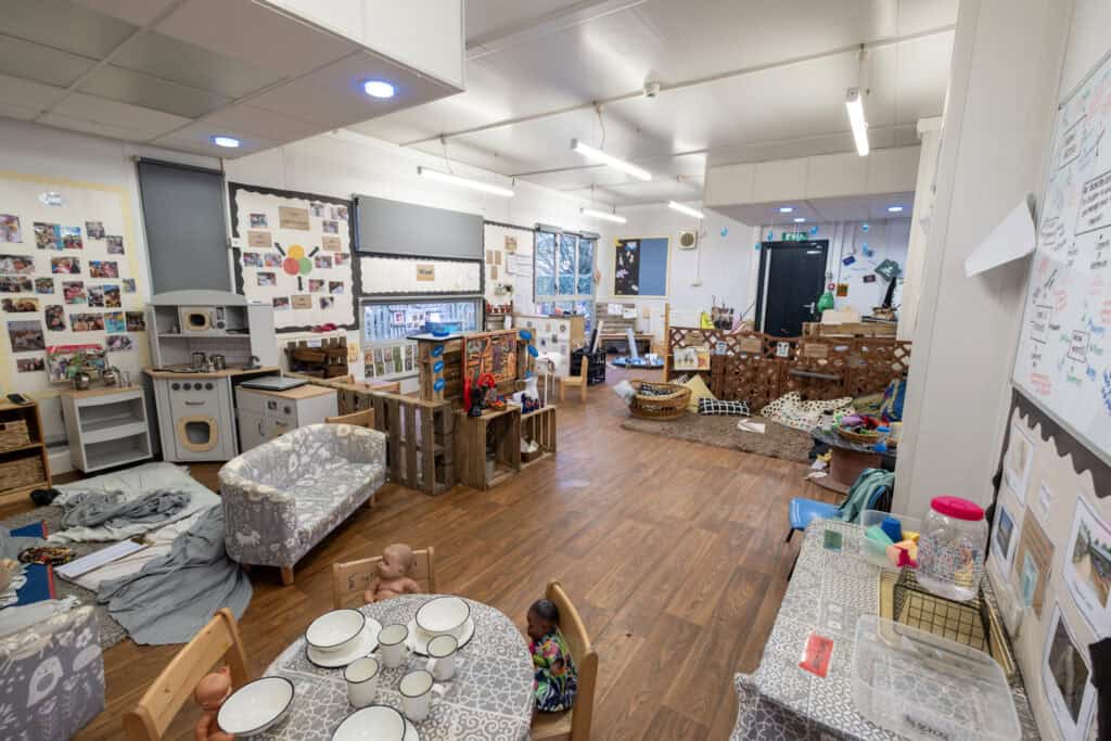 Bright early childhood classroom at Thrive Childcare featuring play areas, learning materials, and colourful decor, designed for nurturing children's development and fostering creativity in a safe environment.