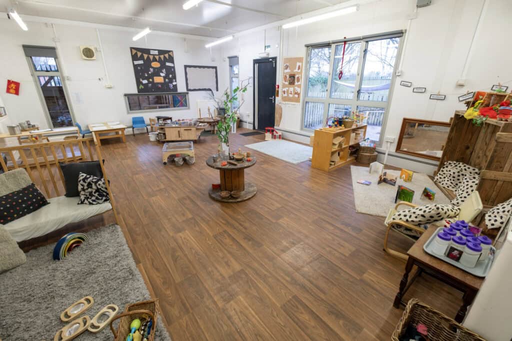 Bright indoor childcare space with play areas, toys, and educational materials at Thrive Childcare, designed to promote early childhood development and learning in a safe, nurturing environment.