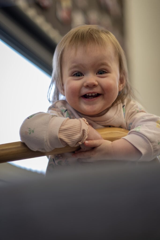 Friendly young child smiling at Thrive Childcare, capturing a joyful moment in a safe and nurturing environment for early childhood development.