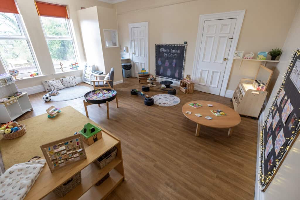 Bright and spacious childcare room at Thrive Childcare featuring engaging play areas, educational toys, and comfortable seating to support early childhood development and learning.
