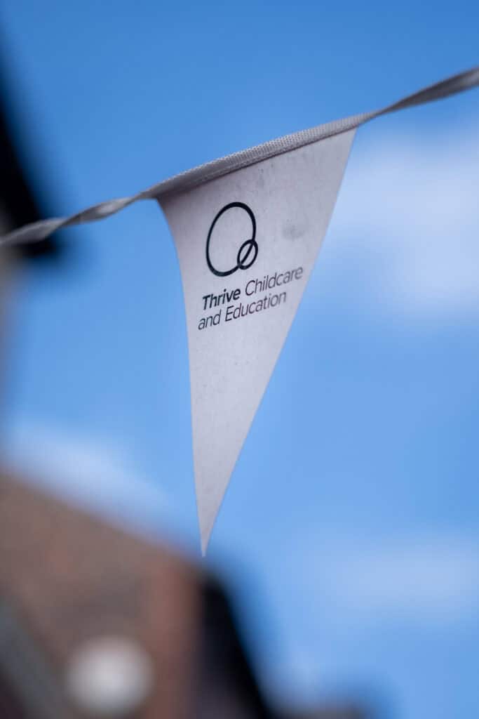 Playful childcare and education flag at Thrive Childcare, promoting early childhood development and learning environment, with clear branding and engaging decor for kids' growth and fun activities.