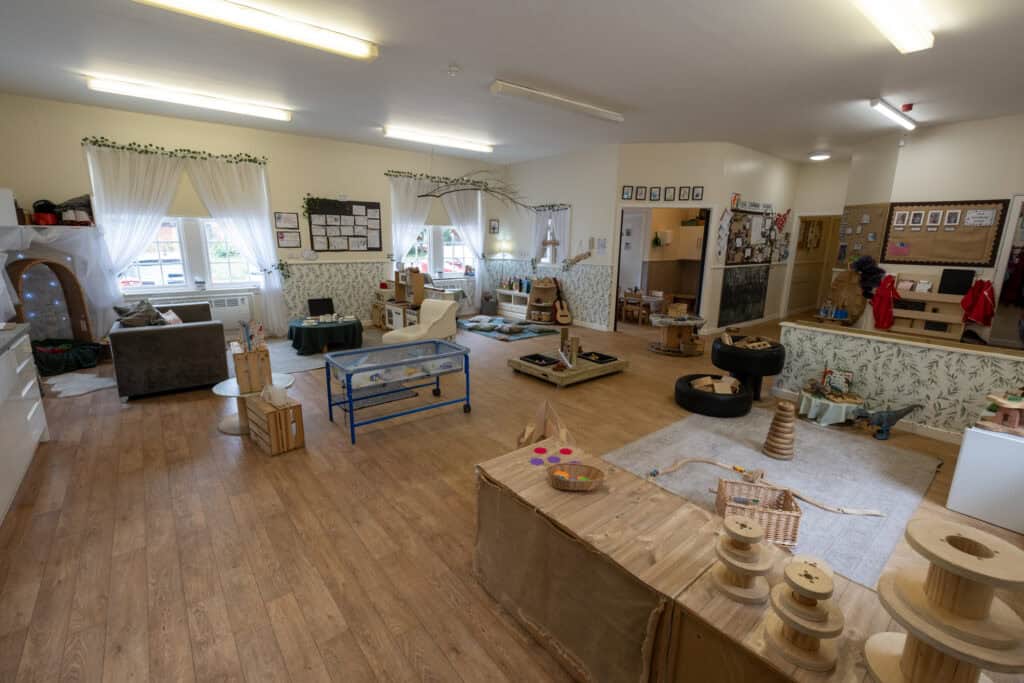Bright indoor early childhood classroom with play areas, toys, and educational materials at Thrive Childcare, designed for nurturing children's development and learning.