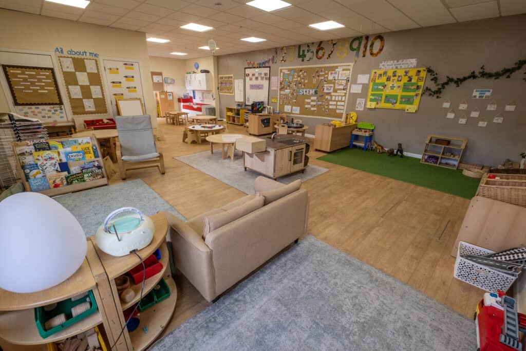 Bright, welcoming toddler classroom at Thrive Childcare featuring educational toys, reading areas, STEM displays, and play zones designed to support early childhood development and learning.