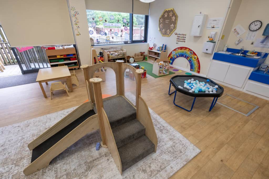 Bright and welcoming childcare playroom at Thrive Childcare, featuring age-appropriate toys, soft play areas, ball pit, and sensory equipment, designed to support early childhood development and learning.