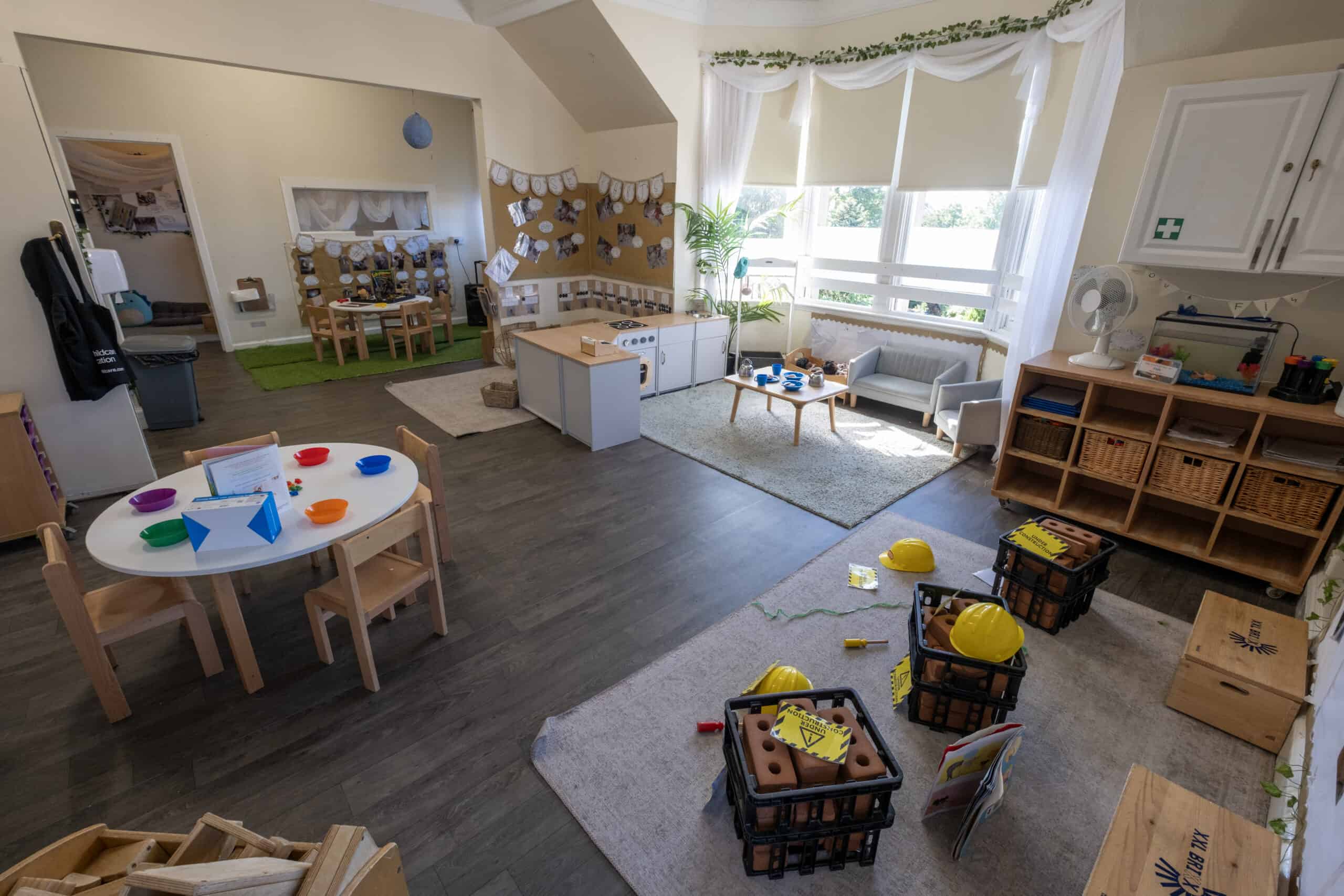 Bright, welcoming childcare indoor space with activity areas, children's furniture, educational toys, and safety features, ideal for early childhood development and learning at Thrive Childcare.