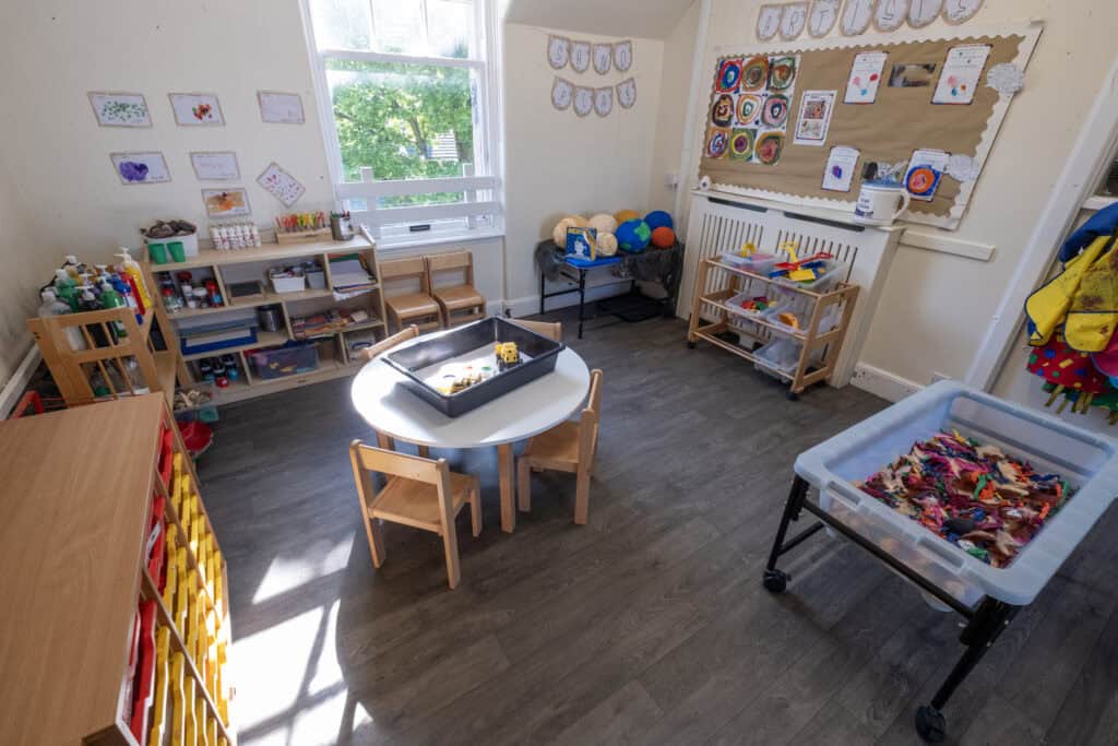 Bright and welcoming Thrive Childcare indoor playroom featuring age-appropriate toys, art displays, and learning areas to support early childhood development and foster creativity.