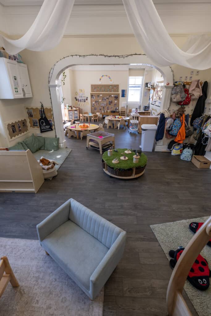 Bright, welcoming childcare classroom at Thrive Childcare with colourful tables, educational displays, and toys, providing a safe, nurturing environment for early childhood learning and development.