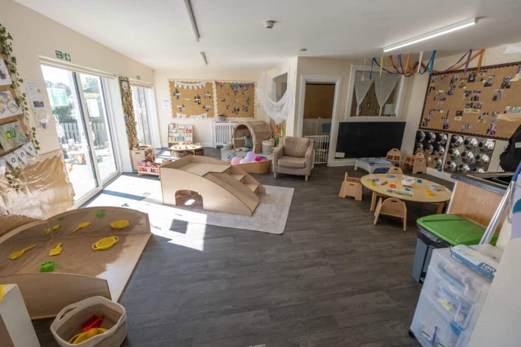 Bright indoor childcare playroom with toys, tables, and cozy areas at Thrive Childcare centre, ideal for learning, socialising, and creative activities for young children.