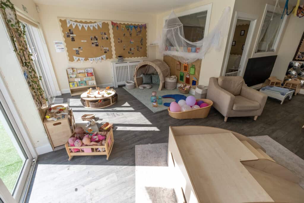 Bright and welcoming Thrive Childcare indoor play area featuring toys, soft seating, and educational displays, designed for early childhood development and learning.