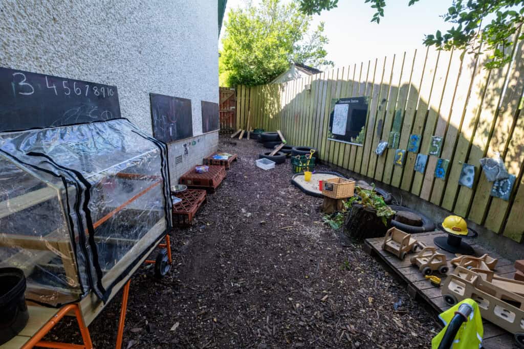 Bright outdoor play area at Thrive Childcare with gardening, educational toys, and creative activities ideal for early childhood development and outdoor learning.