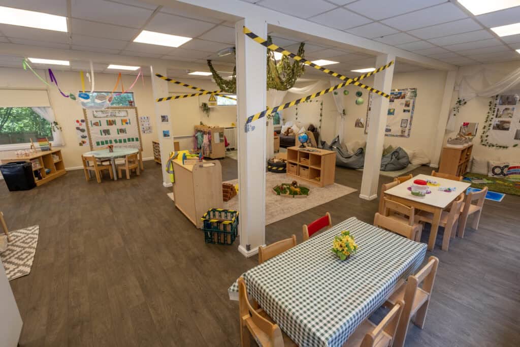 Bright, welcoming childcare room with dedicated play, learning, and relaxation areas, featuring colourful decor, educational toys, and safety features to support child development and ensure a nurturing environment.