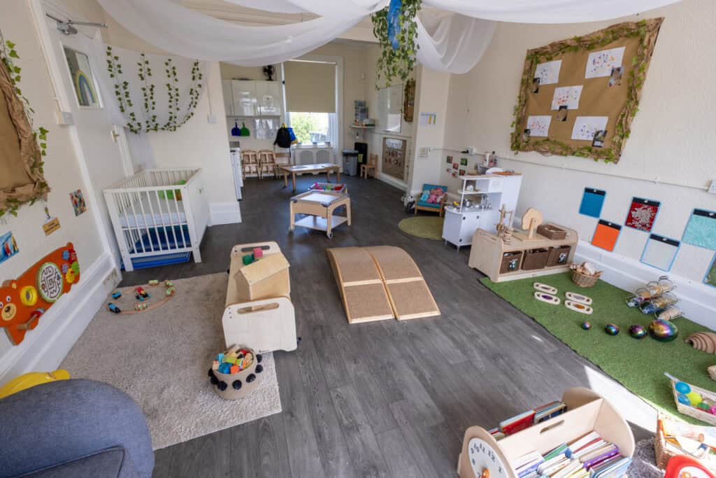 Bright and inviting childcare play area with toys, activity stations, and cosy décor, designed to support early childhood development and learning at Thrive Childcare.