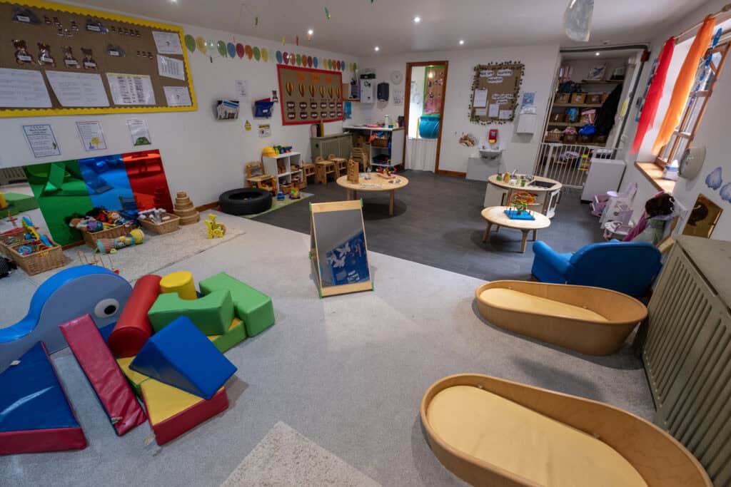 Bright and inviting indoor playroom at Thrive Childcare with colorful toys, soft mats, and educational activities designed for early childhood development and child safety.