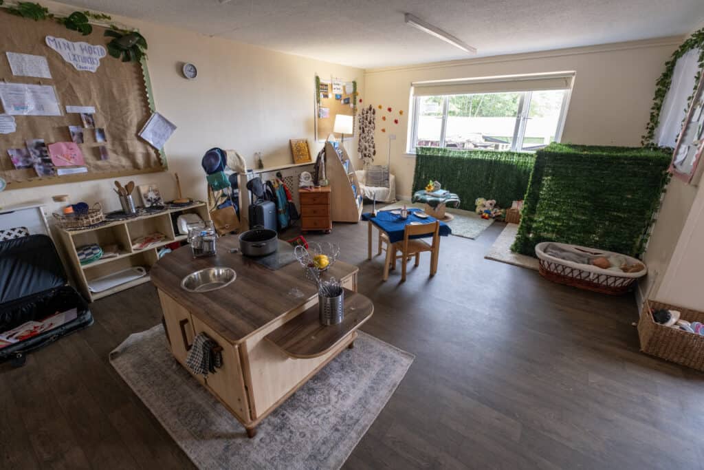 Bright and welcoming childcare room at Thrive Childcare with play areas, child-sized furniture, and educational turns, designed to support early development and learning for young children.