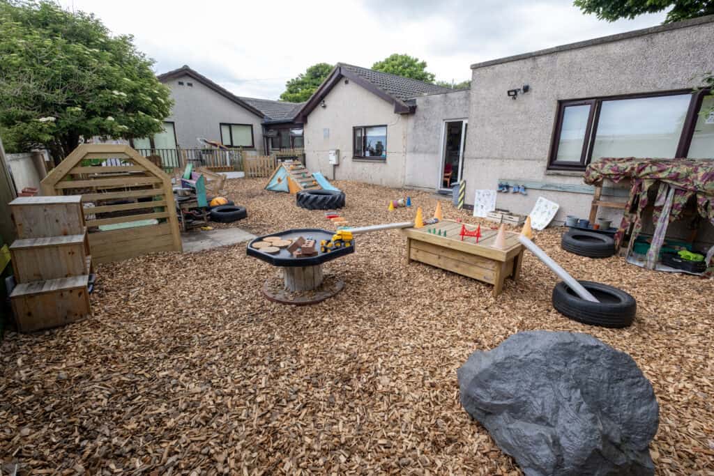 Colourful outdoor childcare play area with toys, climbing equipment, and sensory activities at Thrive Childcare facility. Ideal for early childhood development and child-friendly outdoor learning spaces.