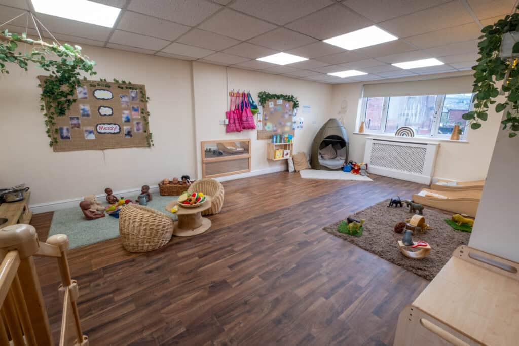 A spacious, bright indoor play area at Thrive Childcare with soft toys, cosy corners, and colourful decorations, designed for early childhood development and playful learning.