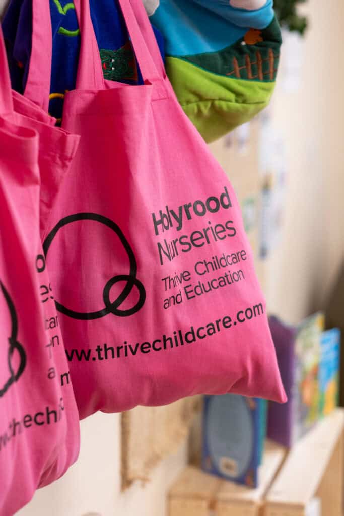 Bright pink nursery tote bag with Thrive Childcare & Education logo, promoting early childhood development and quality childcare services at Thrive Childcare and Nurseries.