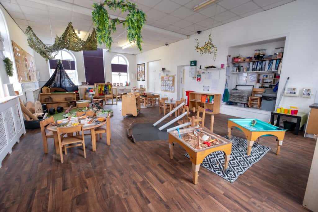 Bright indoor childcare play area with toys, sandboxes, and learning stations at Thrive Childcare centre, designed for early childhood development and imaginative play.
