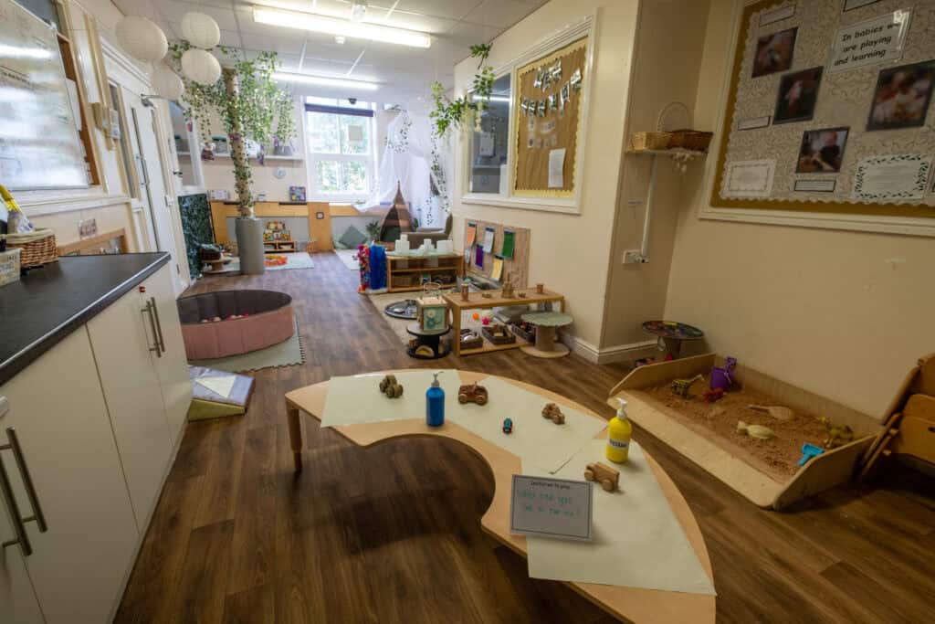 A colourful, well-organised childcare indoor play area with toys, sensory activities, and inviting decor promoting child development and early learning.