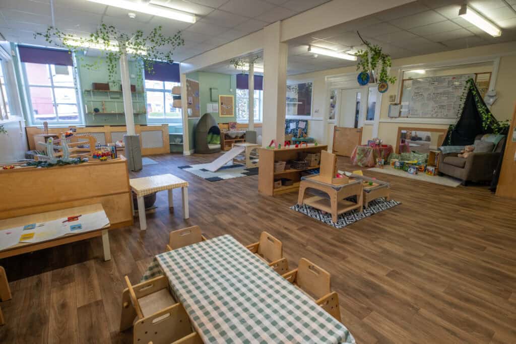 Bright welcoming childcare playroom with toys, play areas, and learning spaces at Thrive Childcare, designed for early childhood development, safety, and engaging activities.