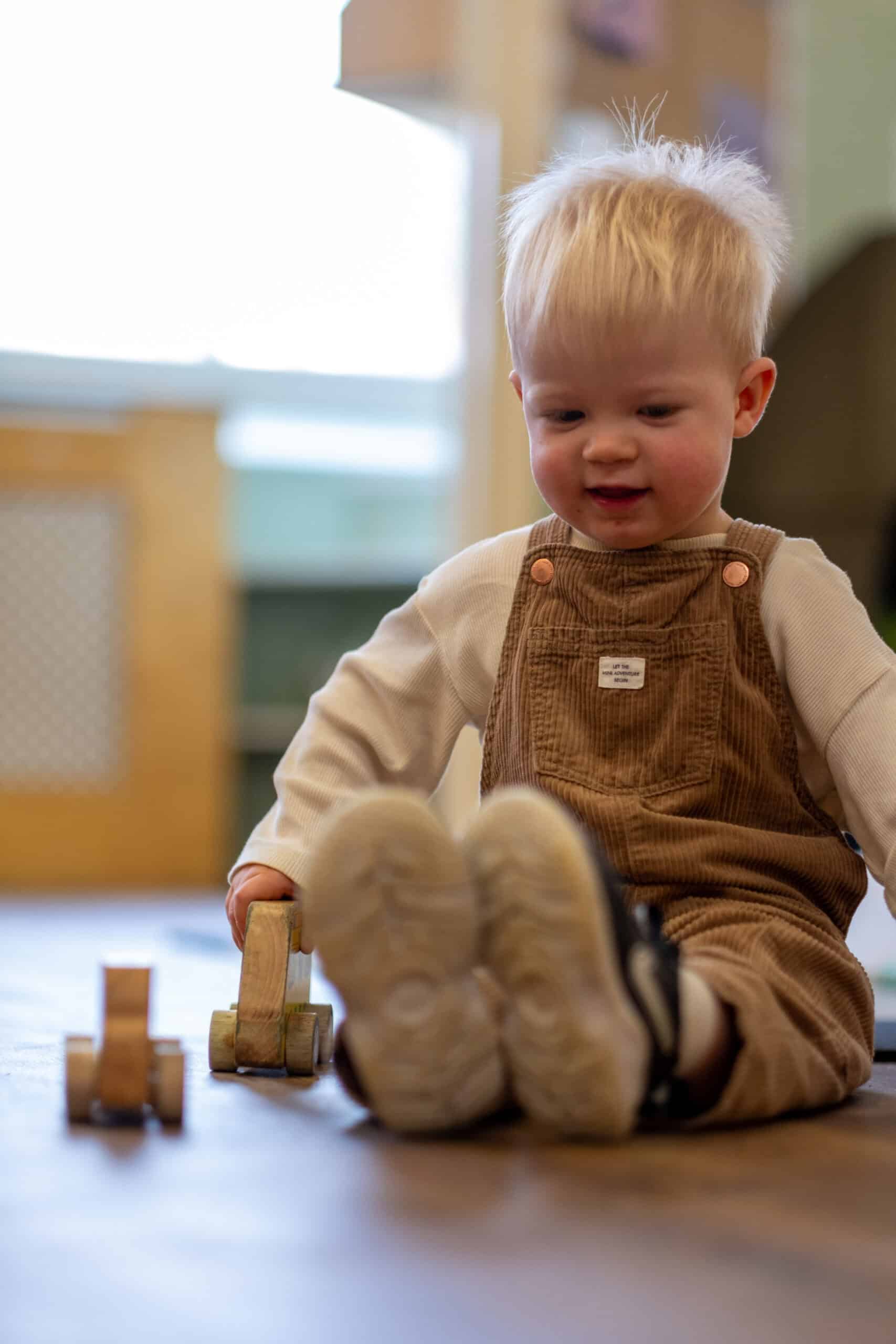 Playful toddler engaging in early childhood development activities at Thrive Childcare in a safe, nurturing environment.