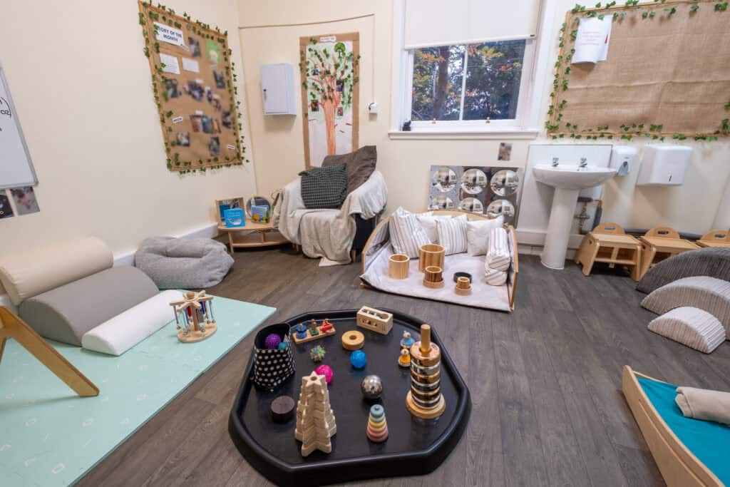 Bright childcare room featuring sensory toys, cosy seating, and educational displays, ideal for early childhood development and safe learning environments at Thrive Childcare.