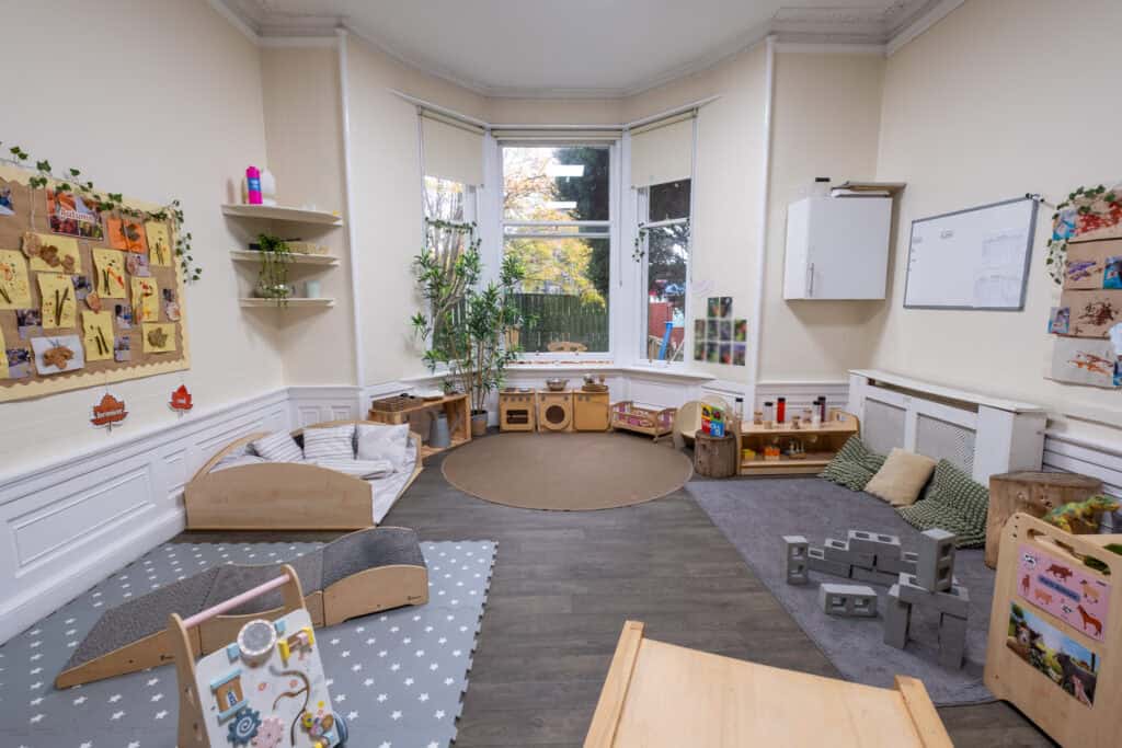 Bright, welcoming nursery playroom at Thrive Childcare with natural light, cosy areas, educational toys, and organised activity zones designed for early childhood development and play.