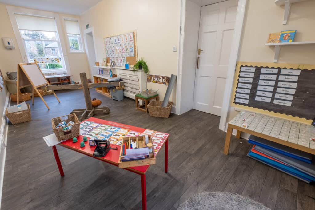 Bright indoor play area and learning space at Thrive Childcare, featuring educational displays, art supplies, and child-friendly furniture for early childhood development and creativity.
