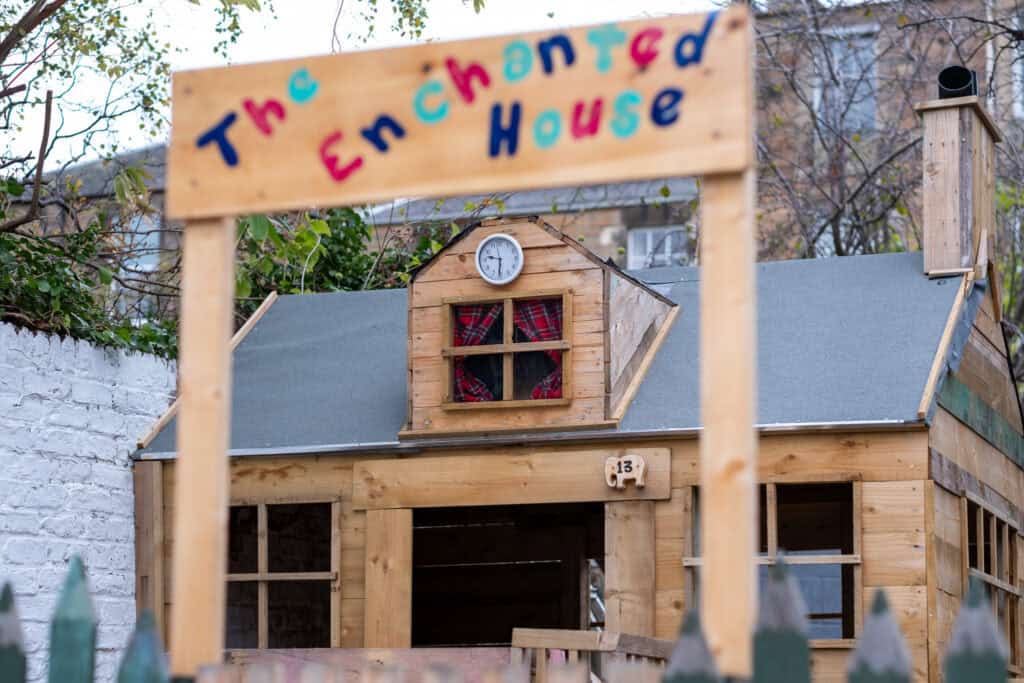 A colourful wooden playhouse for children at Thrive Childcare, designed to encourage imaginative play and outdoor activities for early childhood development.