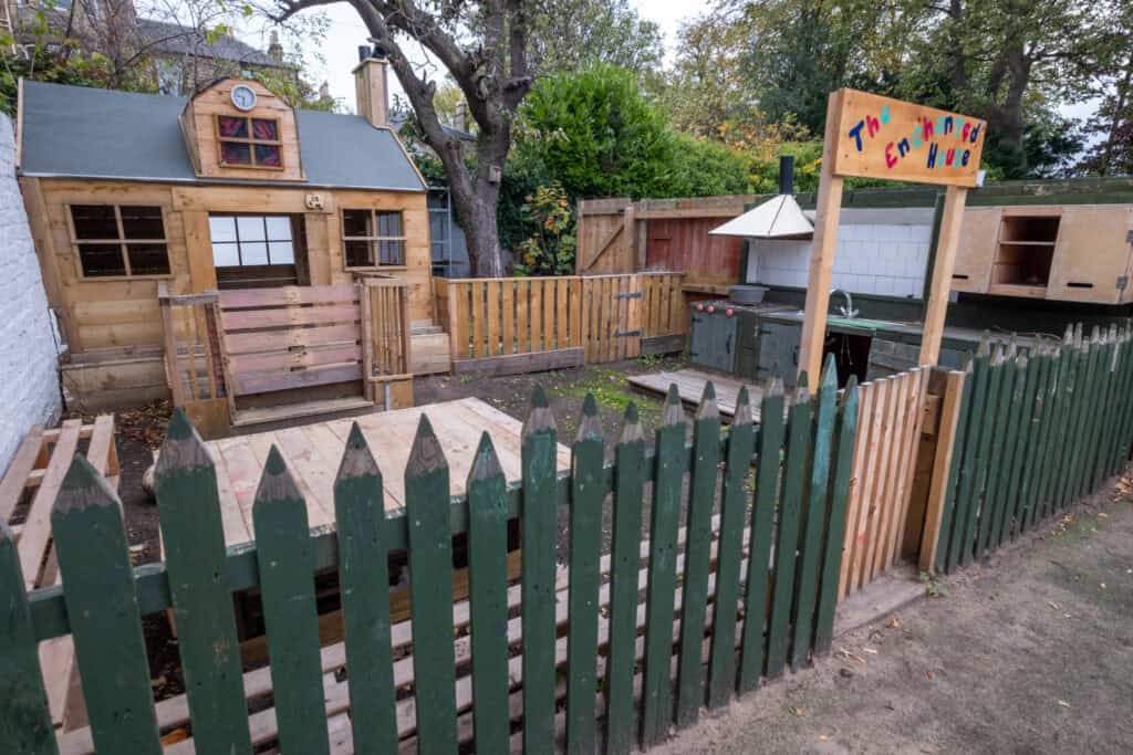 Colourful outdoor playhouse and sandpit area at Thrive Childcare, designed for children’s imaginative play and early learning in a safe, engaging environment.