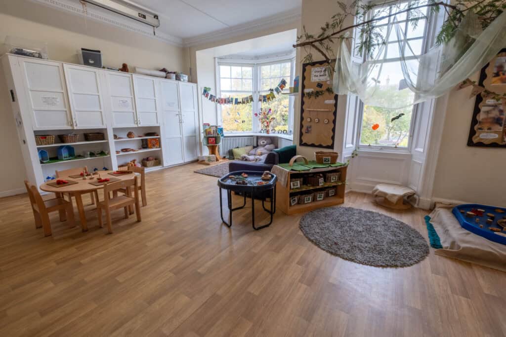 Bright, welcoming nursery room at Thrive Childcare with cosy play areas, toys, and natural light, designed for early childhood development and safe exploration.